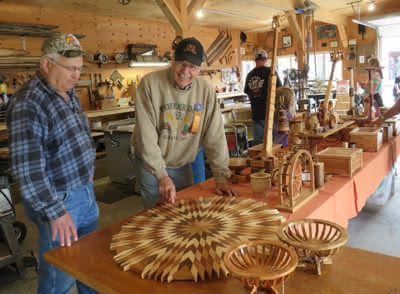 Two men looking at woodworking projects